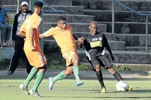 CLOSE ENCOUNTERS: Sipho Gudlindlu, right, of Tornado is poised to clear the ball from Simlindile Zuka of Angavu Stars while a teammate moves close to give support at the North End Stadium in East London yesterday Picture: MARK ANDREWS