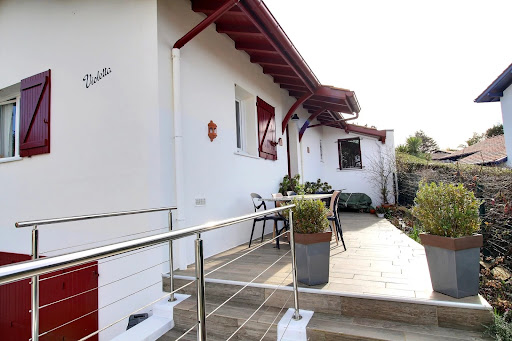 White house facade with red shutters in this luxury property for sale in Guethary ($1,040,201 - 110 m²)