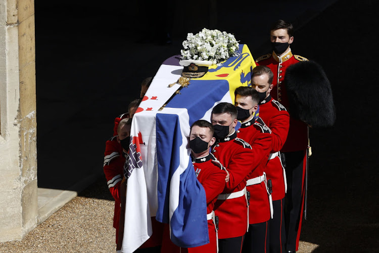 Prince Philip's coffin was draped in his royal standard. This official personalised flag features a cross from the Greek flag and lions from the Danish coat of arms to signify that Philip was born a prince of Greece and Denmark. Black stripes denote that he was part of the Mountbatten family, while a castle represents his rank as the Duke of Edinburgh.