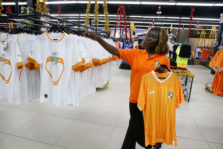 A seller arranges jerseys at a store in Abidjan, Cote d’Ivoire, on December 9, 2023.