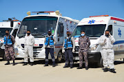 Civil defense members stand outside the new Salt government hospital in the city of Salt, Jordan March 13, 2021. 