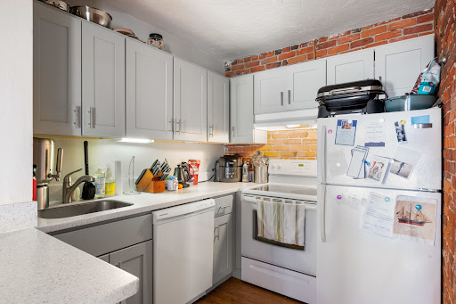 Modern kitchen with exposed brick walls - Property purchase in Boston, 1 bedroom
