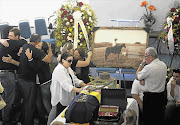 Relatives of Silvio Beuren jnr, who died in the fire at a nightclub in southern Brazil, attend his wake in the city of Santa Maria yesterday. More than 230 people died in the blaze and 82 are in a serious condition in hospital