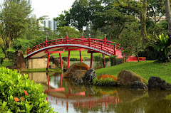 #49068436 - Curved red bridge over stream in Japanes