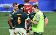 SA director of rugby, Rassie Erasmus, in his capacity as a water carrier, talks to Springbok captain Siya Kolisi, Handre Pollard and Steven Kitshoff  during the second Test against the British and Irish Lions in Cape Town.