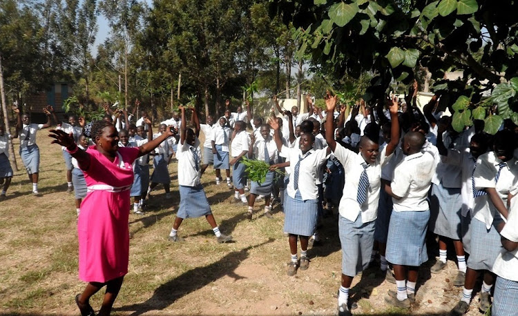 St Thomas Amagoro Girls High School students led by their principal Doris Onyango celebrate their previous year's KCSE results. Private school owners government to cushion teachers in their schools against the effects of COVID-19.