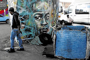 A man pulls a trolley as he makes his way to a recycling place next to Newtown Junction, Johannesburg. The writer says South Africans are depressed by what we believe are our own failures, but we have been trudging through a quagmire of orchestrated inequality and systemic impoverishment since the first colonisers set foot on this land.