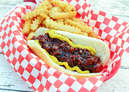 Coney Island hot dog sauce poured over a hot dog.