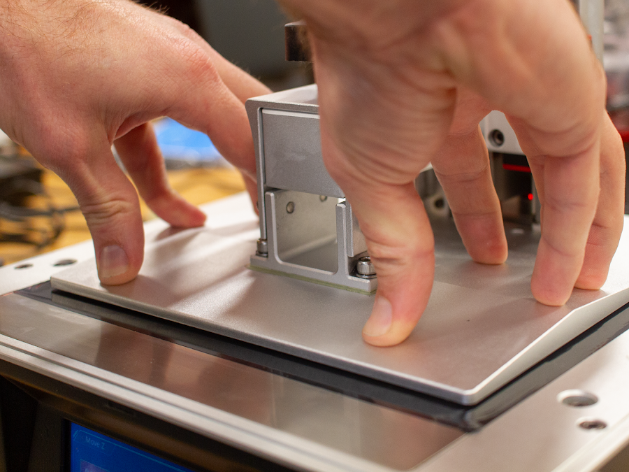 Applying the same light pressure used to flatten the platform against the LCD screen when leveling your build plate should be enough in this step.