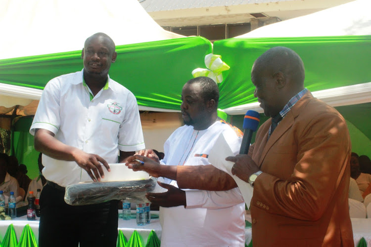 Keystone CEO Allan Kawa, chairman Esau Ogada and Homa Bay ECD director Scofield Manyala during the 44th annual general meeting at Kisumu Museum on Saturday