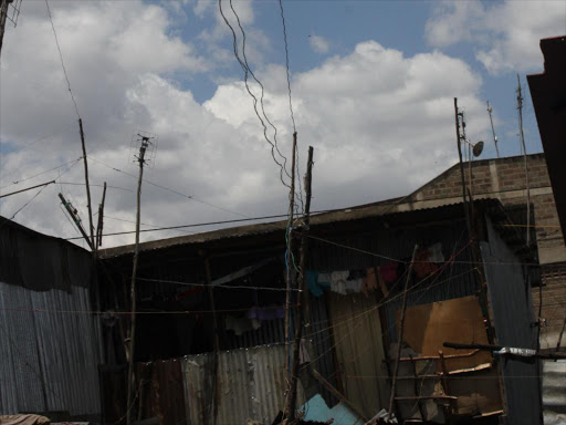 Illegally connected electricity wire passing over the shanty building of Mukuru slam commonly known as Kisii village in Nairobi south B on October6th,2014. PHOTO/FILE