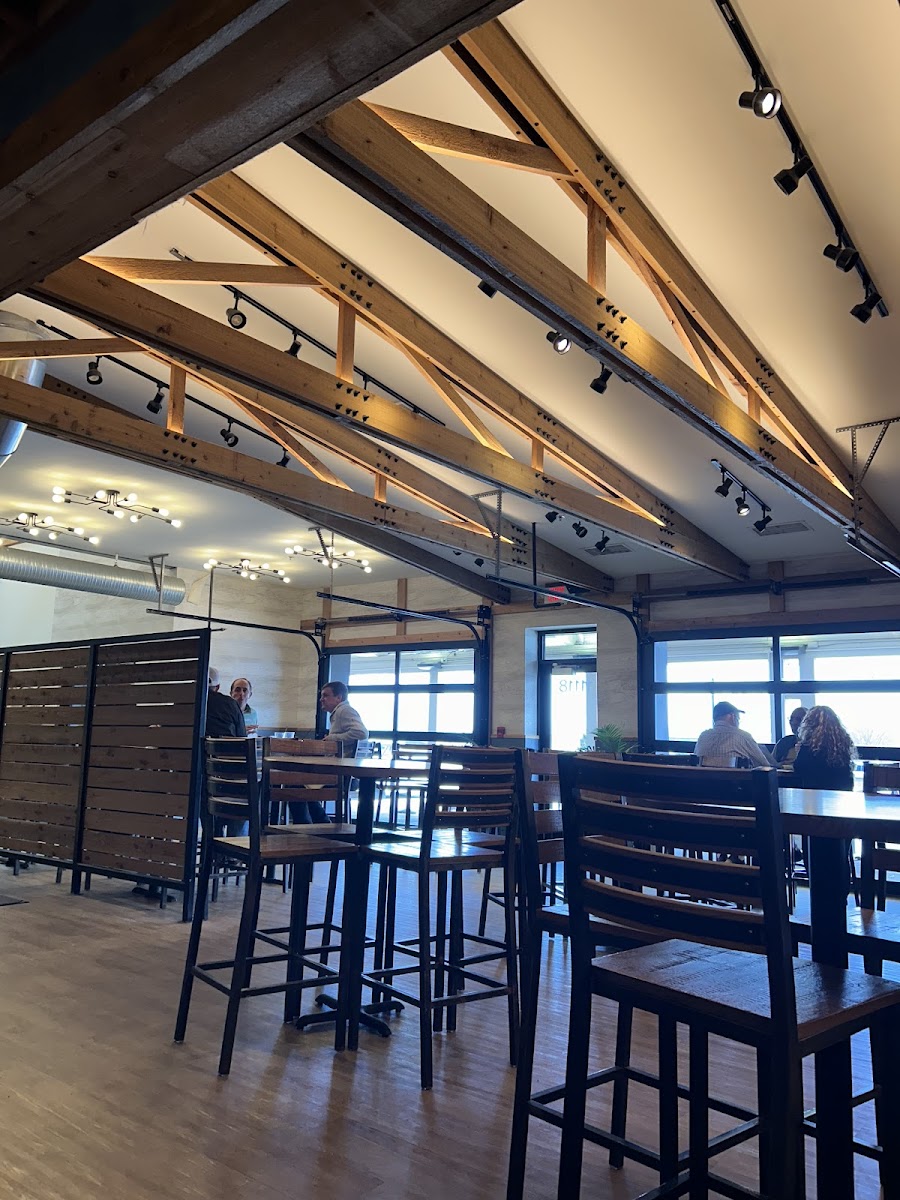 Inside restaurant with view of garage doors and patio