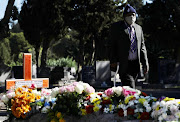 A relative of Lungile Tom leaves the cemetery after the cameraman's funeral on Tuesday.