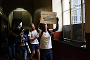 Wits University,  Johannesburg. Police monitored  while a protest by Wits University students was underway.  The police mainly stayed outside  the institution's gates on Wednesday morning.Students were protesting about fee increases along with other matters.Protestors blocked cars from entering or leaving various entrances and exits of the campus causing a traffic jam in the morning and inconveniences later on. Some students also disrupted lectures.  PHOTOGRAPH: ALON SKUY