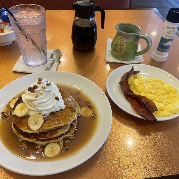 Banana Fosters pancakes, scrambled eggs and bacon.