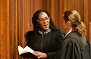 Rape survivor Andy Kawa speaks to Nicole Lewis, who is part of her legal team, in court. File picture