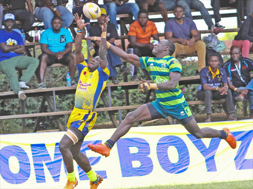 Homeboyz' Leonard Mugaisi vies for the ball with KCB's Jacob Ojee during the 2018 Christie 7s.jpg