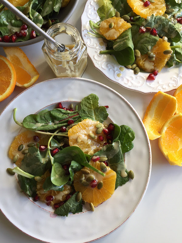 salad with orange, pomegranate, pepitas, maple tahini dressing