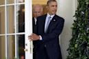 President Barack Obama, followed by Vice President Joe Biden, leave the Oval Office of the White House in Washington, Monday, June 30, 2014, to walk to the Rose Garden where the president spoke about immigration reform. The president said he's done waiting for House Republicans to act on immigration. He says he now plans to act on his own. Obama announced his intention Monday to take executive action. (AP Photo/Manuel Balce Ceneta)