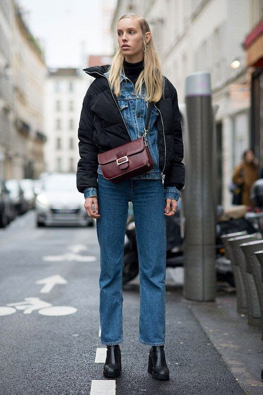 Le Fashion Blog Couture Fashion Week Street Style Model Denim Jacket Black Puffer Coat Straight Leg Jeans Maroon Crossbody Bag Black Heeled Boots Via Stylecaster 