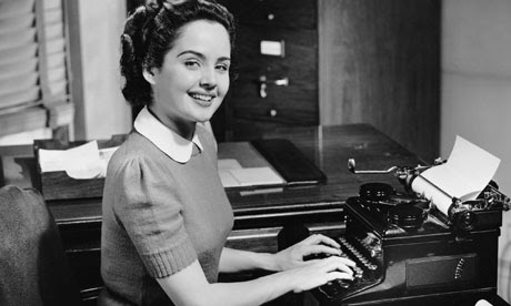 Secretary typing in old-fashioned 1950s-style office