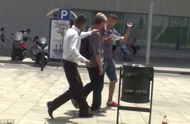 Distracted: An accomplice (left) then plays drunk so he can get close enough to the target to strike