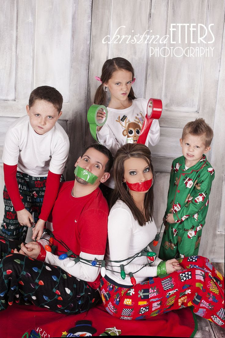 cute family christmas photo, kids take parents hostage