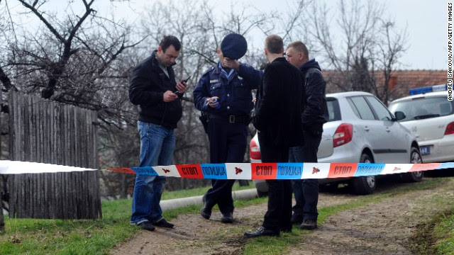 Serbian police officers guard entrance to a yard in the village of Velika Ivanca, on April 9, 2013.
