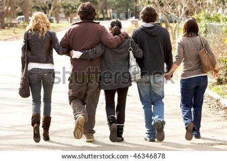 stock photo : A lovely family holding eachother walking away from camera