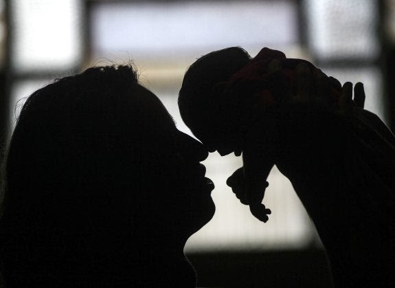 Una mujer brasileña sostiene a su nieta, con microcefalia. :: Antonio Lacerda / Efe