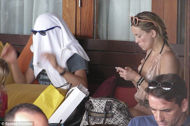 Normal: While Kate checked her phone, Matt continued to play with Bingham 