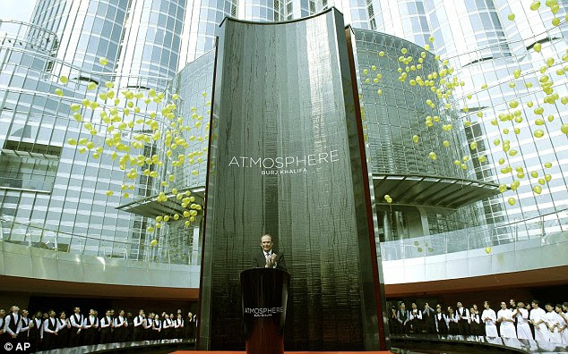 Grand opening: Marc Dardenne, CEO of the Emmar Hospitality Group claps as the staff of At.mosphere release balloons in front of the Burj Khalifa