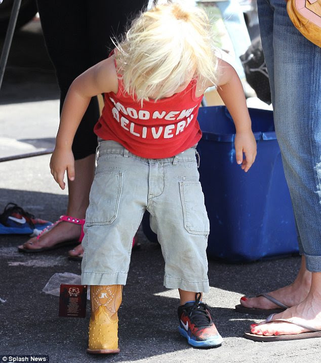 Making his mind up: Zuma, three, tried on a pair of adorable cowboy boots