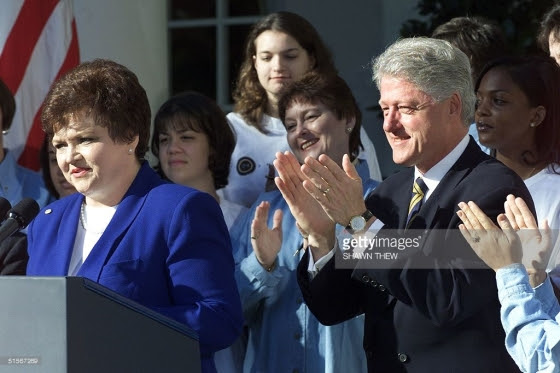 US President Bill Clinton applauds Millie Webb (L), National President of Mothers Against Drunk Drivers (MADD), 23 October 2000 at the White House