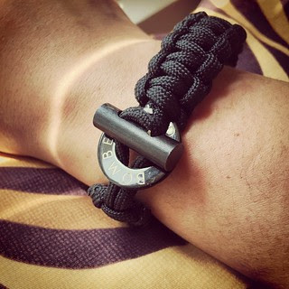 Paracord survival bracelet from Bomber and Co. Slight fraying on the edge but got it at a discount so that's OK. What's especially cool is that the buckle is a steel ring and flint piece that can be used to spark a fire with some tinder.