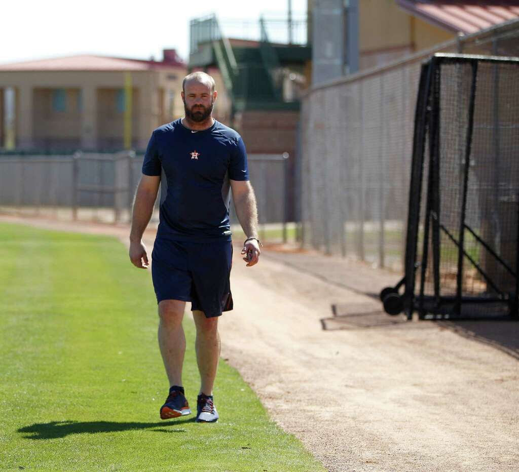 Houston Astros Evan Gattis walks around a field as he worked with assistant athletic trainer, James Ready, during report day for Houston Astros pitchers and catchers at their Osceola County facility, in Kissmmee, FL, Thursday, Feb. 18, 2016. Photo: Karen Warren, Houston Chronicle / © 2015  Houston Chronicle