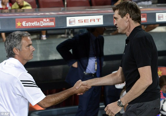 The shake: Jose Mourinho and Francesc 'Tito' Vilanova prior to the match. Mourinho was punished after apparently gouging Vilanova's eye during a La Liga match last season