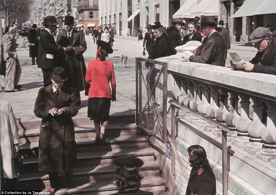 Life goes on: Parisians go about their business, walking down into a subway. The majority of Zucca's images show Paris as a thriving, lively city 