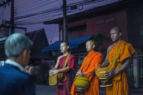 muay thai star buakaw collects morning alms