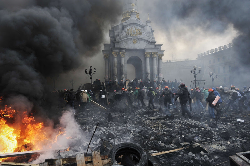 Description of  Protesters advance towards new positions in Kiev on February 20, 2014. Armed protesters stormed police barricades in Kiev on Thursday in renewed violence that killed at least 26 people and shattered an hours-old truce as EU envoys held crisis talks with Ukraine's embattled president. Bodies of anti-government demonstrators lay amid smouldering debris after masked protesters hurling Molotov cocktails and stones forced police from Kiev's iconic Independence Square -- the epicentre of the ex-Soviet country's three-month-old crisis.  AFP PHOTO / LOUISA GOULIAMAKI
