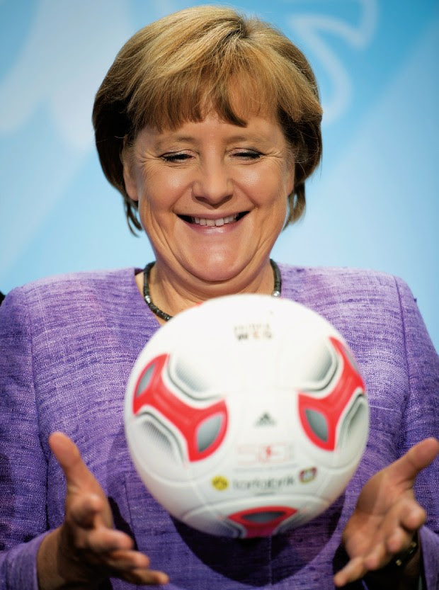 GERMÂNIA futebol clube A chanceler da Alemanha, Angela Merkel, brinca com uma bola durante uma entrevista, em 2012. A gestão mais austera explica o  sucesso dos clubes de futebol alemães (Foto: Odd Andersen/AFP/GettyImages)