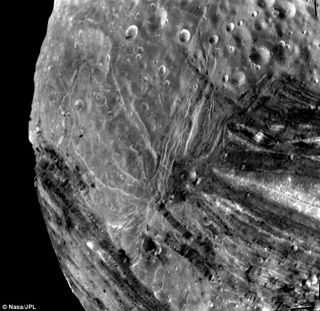 Voyager 2 image of Miranda taken shortly before closest approach on 24 January 1986 at a range of 19,000 miles. Miranda's giant fault canyons are as much as 12 times as deep as the Grand Canyon.