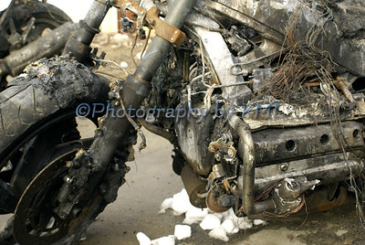 a motorcycle wreck in a salvage yard