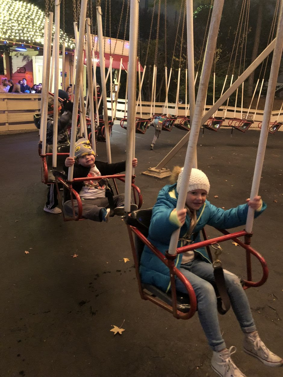 child with down syndrome riding the swings at six flags over texas