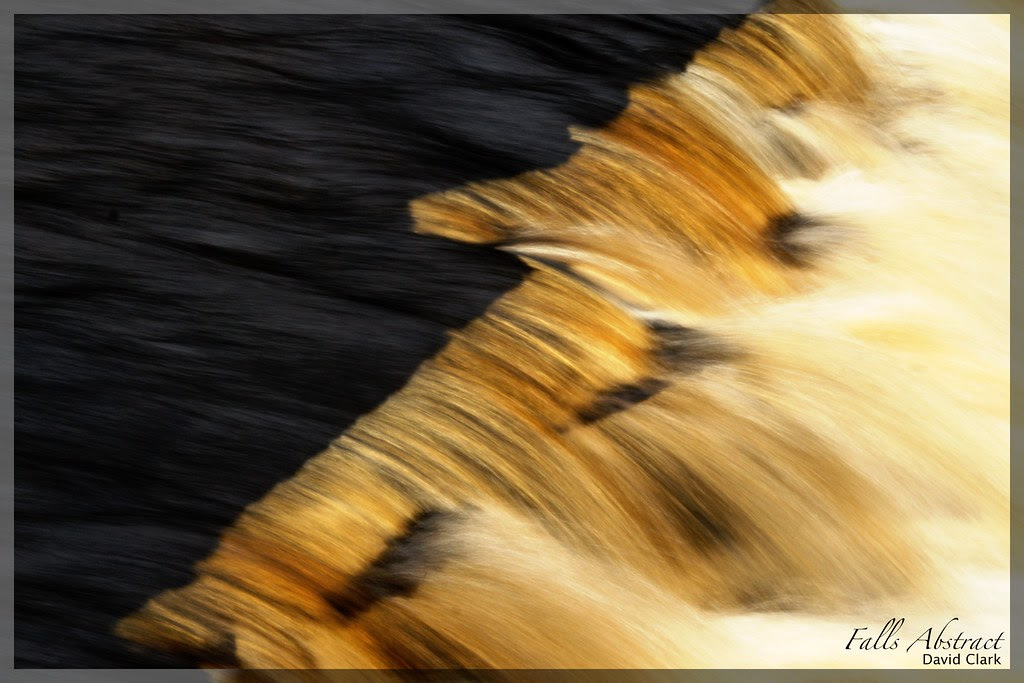 The rocks under a waterfall's edge, sharp and jagged.