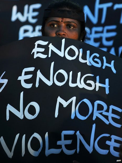 A sign reading "Enough is enough, no more violence"
