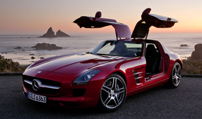 A three-quarter front view of a red 2011 Mercedes-Benz SLS AMG
