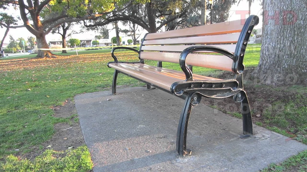 outdoor public wooden park bench w/ metal wrought or cast