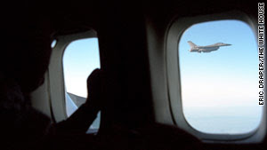 Air Force F-16s fly off the wingtips of Air Force One.