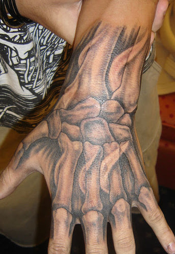 Tattoo of bones in the hand. Here is a way to stay down with Halloween year